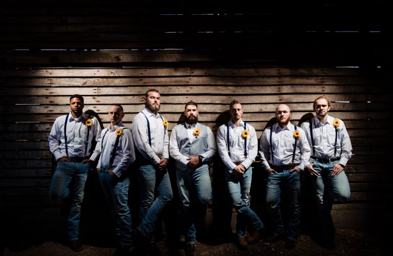 Groomsmen gathered inside the corn crib before the ceremony.