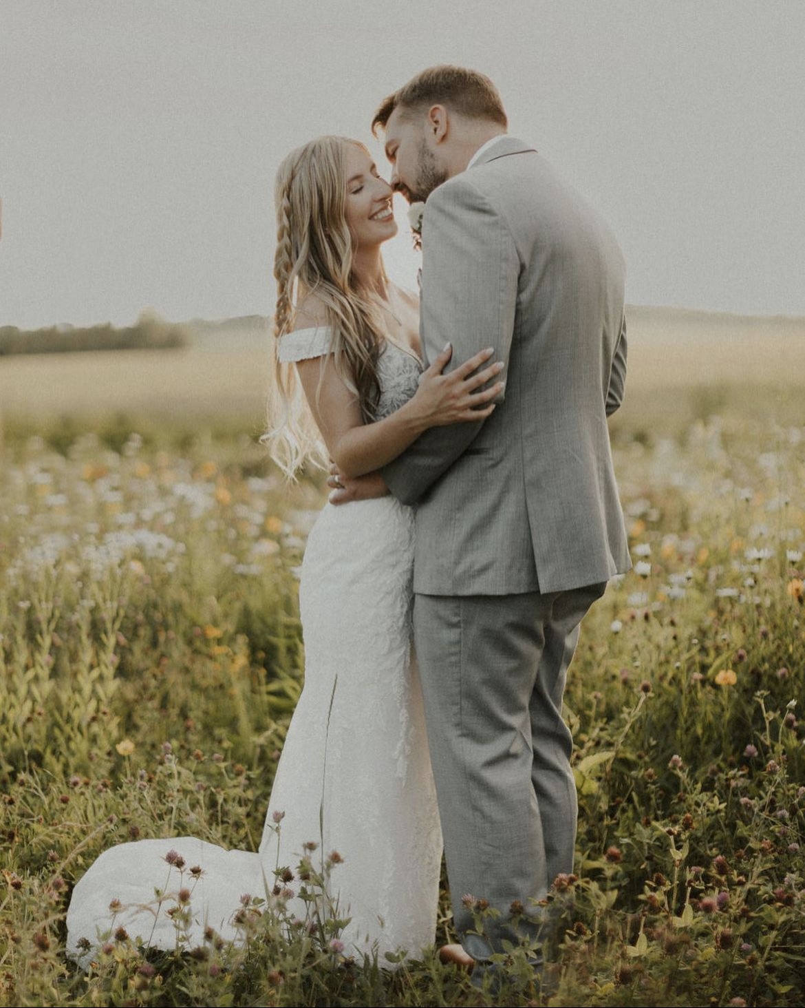 A couple together out in the wildflowers.