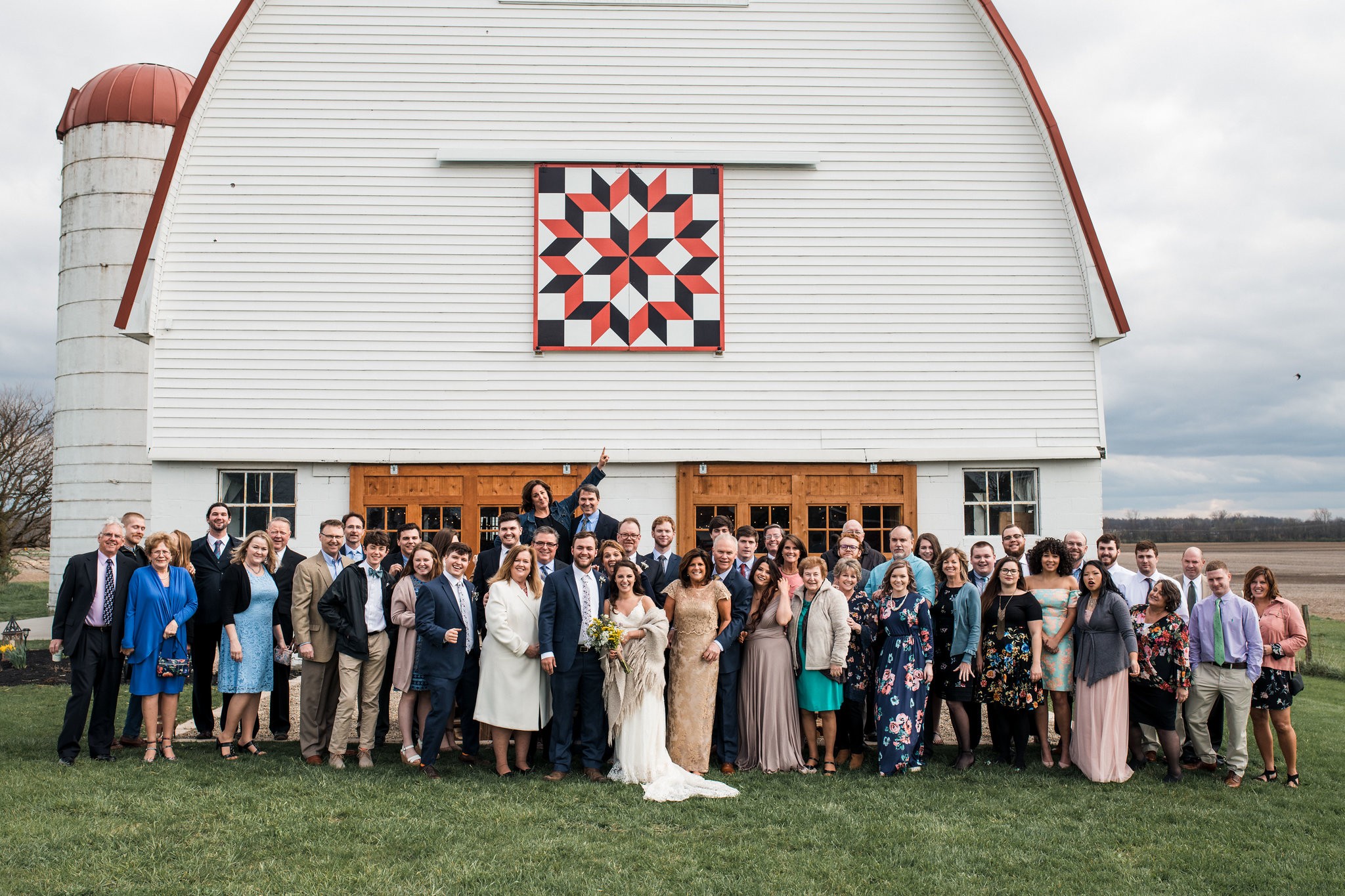 The whole wedding gathered in front of the barn for a group portrait.