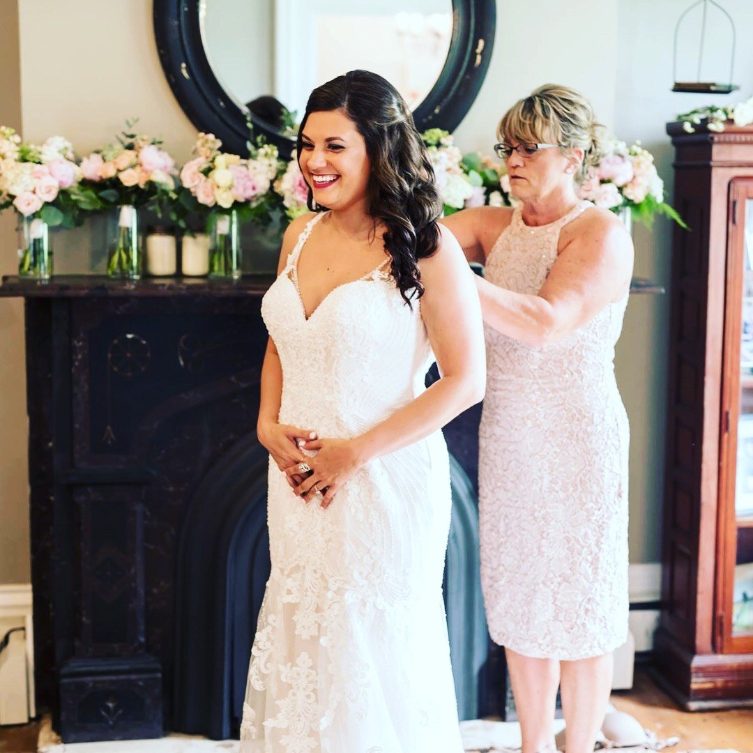 The last buttons on the back of the bride's gown in the farmhouse bridal suite.