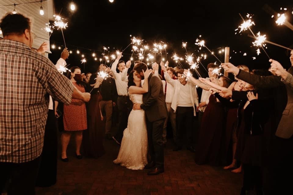 Guests forming a sparkler line around the newlyweds at the end of the night.